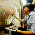 Interactive Virtual tour -  Thailand  Artist working on restoring old mural paintings in teh temple of the reclining Buddha