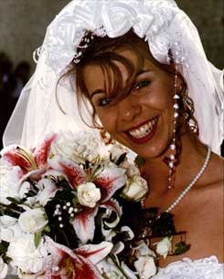 Bride with flowers - digitally photographed by experienced wedding photographer Bo Lorentzen - picture is of Kimberly with beautiful backlight in the hair