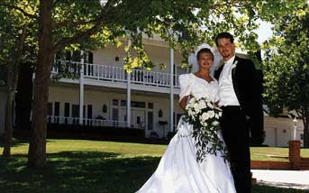 Thacher Manor wedding location with couble posed in front for their official formal wedding portrait, this was a favorite image with the family - digital and traditional wedding film based wedding photography for every 20 years by Danish photographer Bo Lorentzen